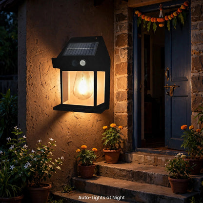 Lamp lit on home wall at night